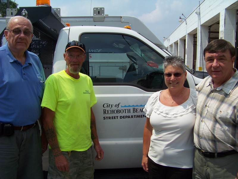 Johnny Elliott is a hearing-impaired new employee with the Rehoboth Beach Public Works Department. Elliott has been hearing-impaired his whole life. Shown are (l-r) public works Director Mel Craig, Elliott, social worker Mary Jo Verdery and City Manager Greg Ferrese. BY RYAN MAVITY